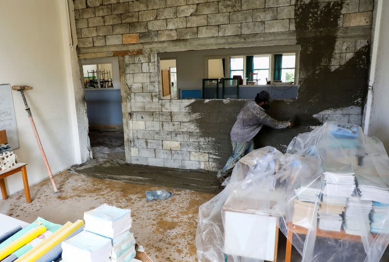 A man works inside Sagesse Beyrouth school which was damaged due to the explosion at the port area, in Beirut