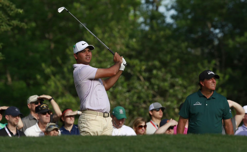 Jason Day watches his tee shot on the 13th hole as Phil Mickelson, right, looks on during the first round of the Wells Fargo Championship golf tournament at Quail Hollow Club in Charlotte, N.C., Thursday, May 2, 2019. (AP Photo/Jason E. Miczek)
