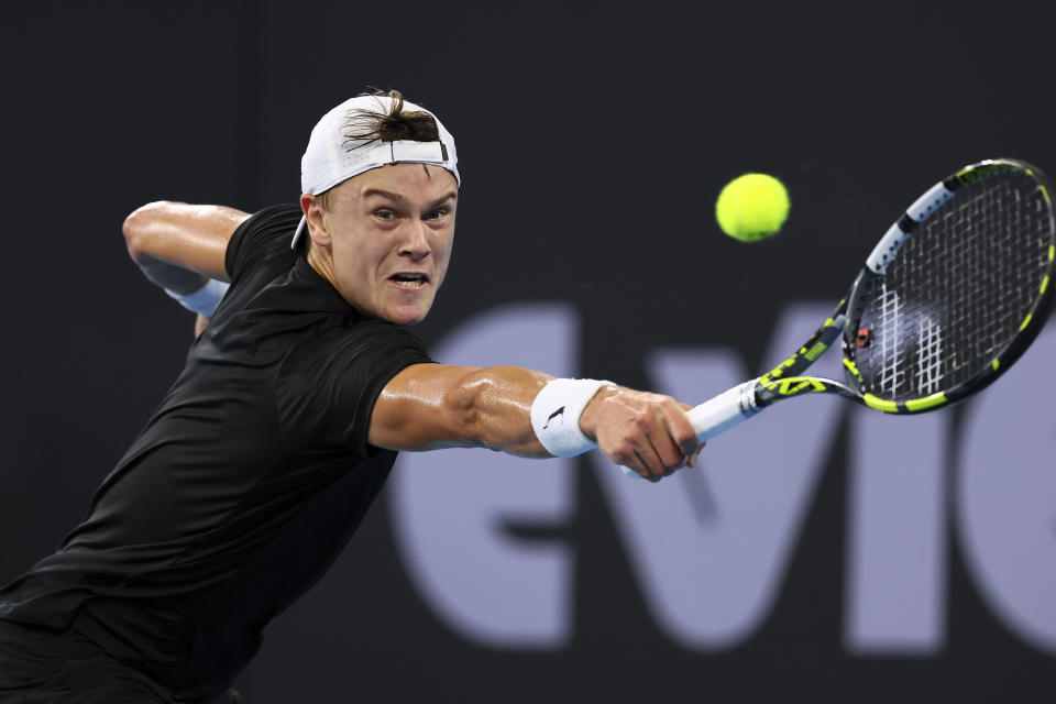 Holger Rune of Denmark plays a shot in his final match against Grigor Dimitrov of Bulgaria during the Brisbane International tennis tournament in Brisbane, Australia, Sunday, Jan. 7, 2024. (AP Photo/Tertius Pickard)