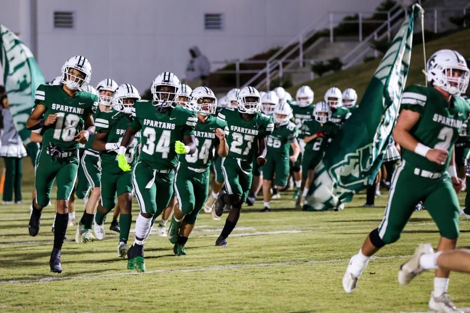 Spartan fooball players run out before the game against Mount Pisgah Christian School at Slaughter Field at Athens Academy in Athens, Ga., on November 13, 2021. (Photo by Chamberlain Smith for Athens Banner-Herald)