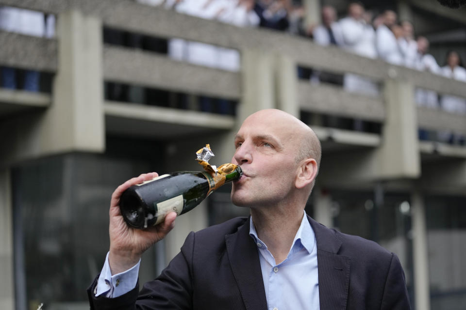 German scientist Benjamin List drinks champagne as arrives at the Max-Planck-Institute for Coal Research in Muelheim, Germany, Wednesday, Oct. 6, 2021. Two scientists have won the Nobel Prize for chemistry for finding an "ingenious" new way to build molecules that can be used to make everything from medicines to food flavorings. Benjamin List of Germany and Scotland-born David W.C. MacMillan developed "asymmetric organocatalysis." (AP Photo/Martin Meissner)