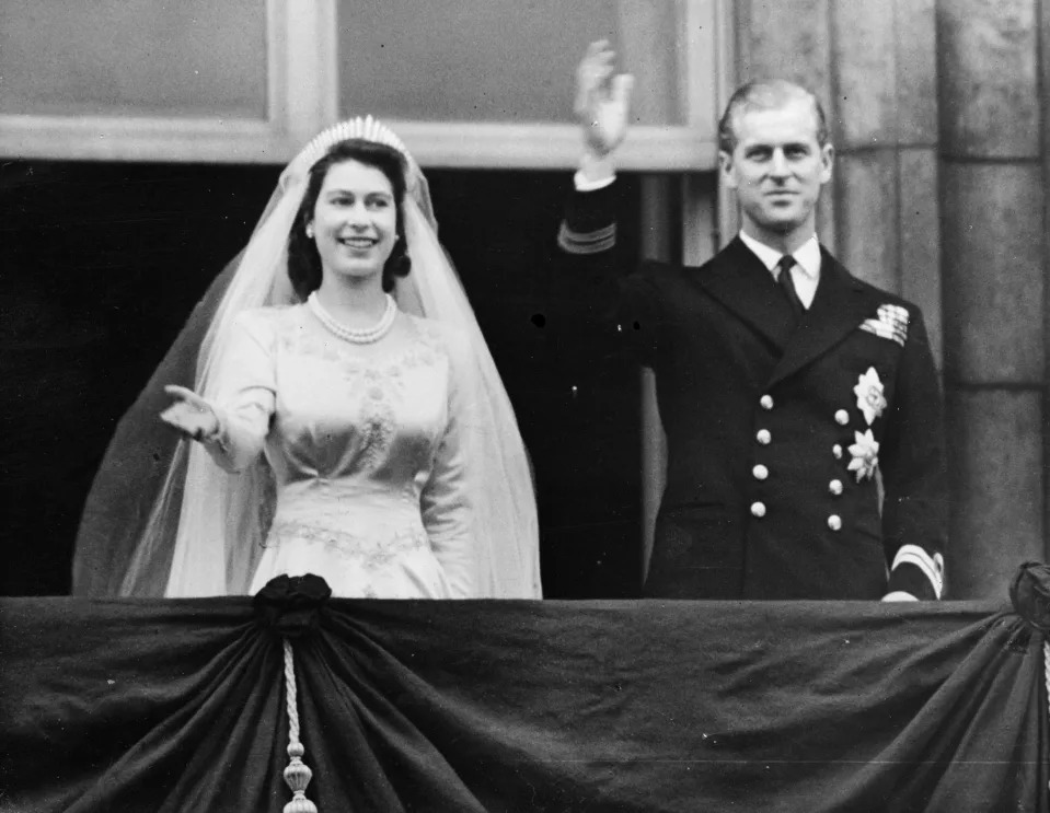 <p>Princess Elizabeth and Prince Philip, Duke of Edinburgh, wave to a crowd from the balcony of Buckingham Palace, London, shortly after their wedding at Westminster Abbey on 20 November 1947. (Getty Images)</p> 