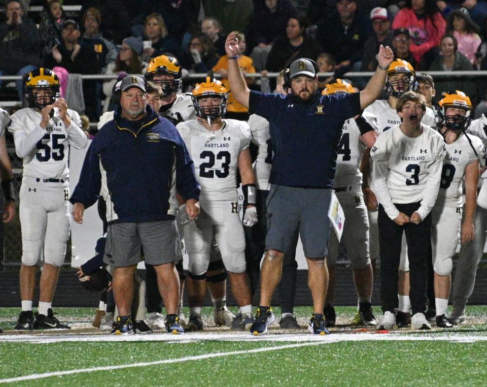 New Hartland head football coach Thomas Stevenson (arms raised) has been the Eagles' defensive coordinator since 2016.