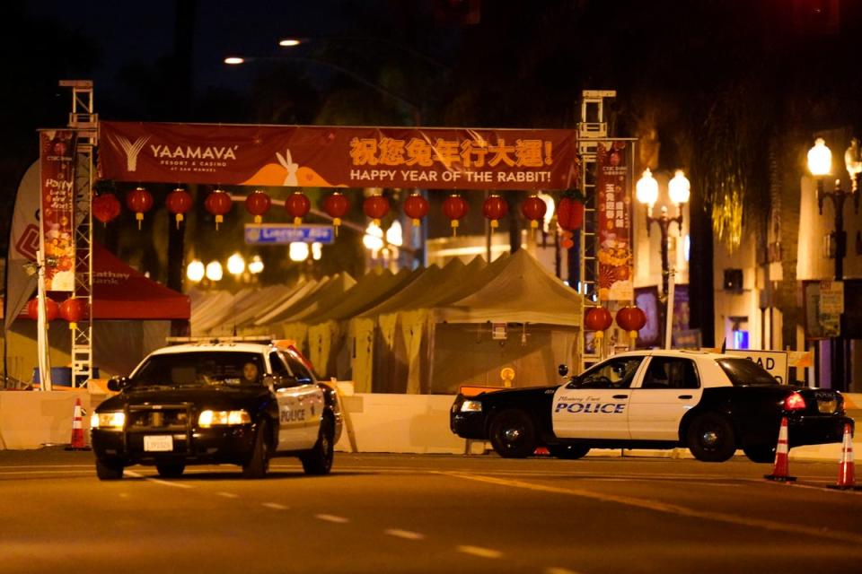 Two police vehicles are seen near a building where a shooting occurred in Monterey Park (Copyright 2023 The Associated Press. All rights reserved)