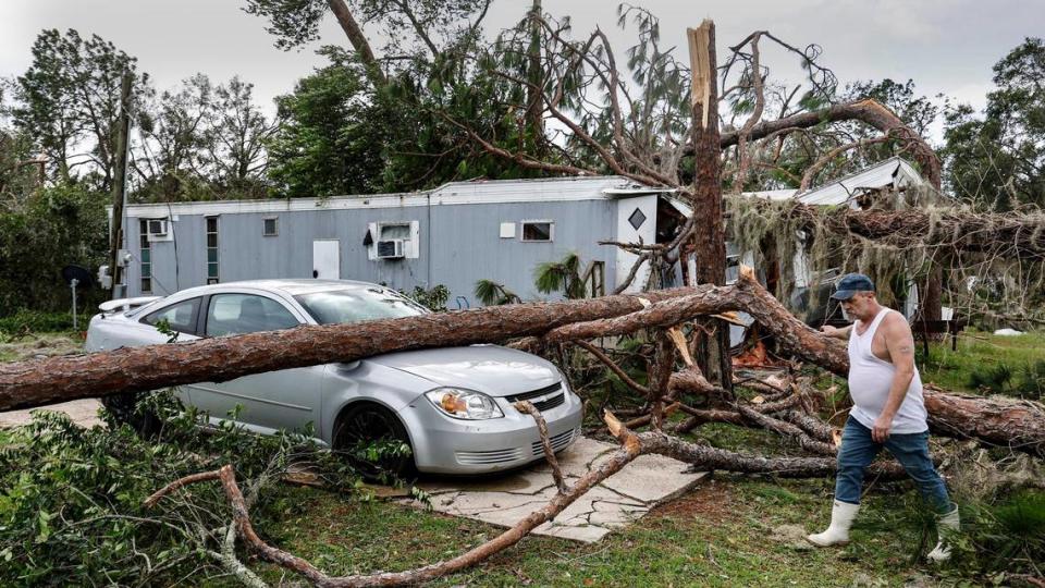 Mike Maclin, 53, walks past his neighbor’s mobile home damaged by Hurricane Idalia at Perry Cove Mobile Home and RV Park in Perry, Florida on Wednesday, August 30, 2023.