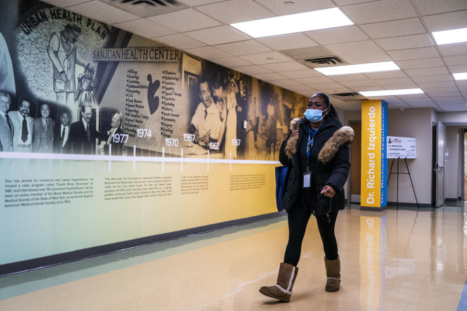 A woman walks at El Nuevo San Juan Health Center in the Bronx borough in New York, Thursday, Jan. 11, 2024. (AP Photo/Eduardo Munoz Alvarez)