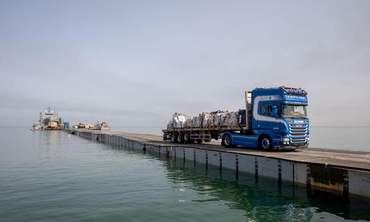 <span>A truck carries humanitarian aid across Trident Pier to deliver to residents of the Gaza Strip.</span><span>Photograph: US Army Central/Reuters</span>