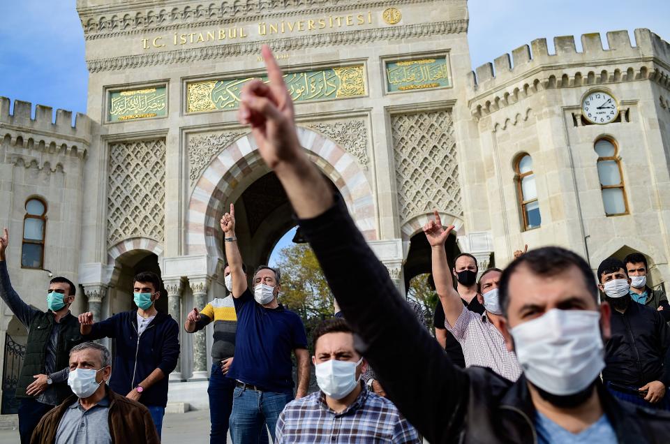 Men raise their finger as Turkish protesters shout slogans against France during a demonstration against French President's comments over Prophet Muhammad cartoons, in Istanbul, on October 25, 2020. - Turkish President Recep Tayyip Erdogan on October 25, 2020 renewed his call for his French counterpart Emmanuel Macron to undergo mental checks, a day after his comments prompted Paris to recall its envoy to Ankara. Macron's comments, on October 21, 2020, came in response to the beheading of a teacher, Samuel Paty, outside his school in a suburb outside Paris earlier this month, after he had shown cartoons of the Prophet Mohammed during a class he was leading on free speech. (Photo by Yasin AKGUL / AFP) (Photo by YASIN AKGUL/AFP via Getty Images)