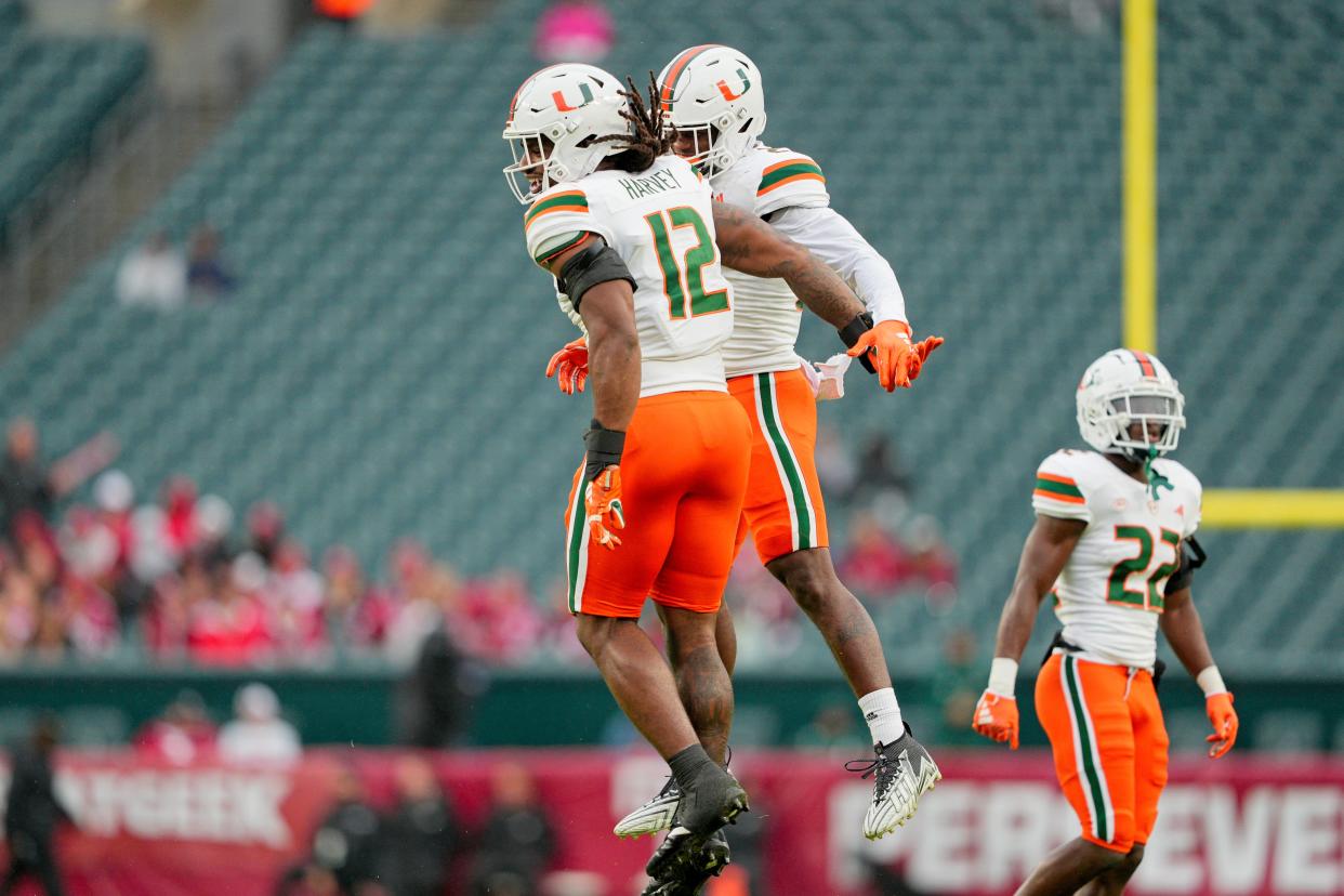 Sep 23, 2023; Philadelphia, Pennsylvania, USA; Miami Hurricanes defensive lineman Jahfari Harvey (12) celebrates his fumble recovery with linebacker K.J. Cloyd (23) in the second half against the Temple Owls at Lincoln Financial Field. Mandatory Credit: Andy Lewis-USA TODAY Sports