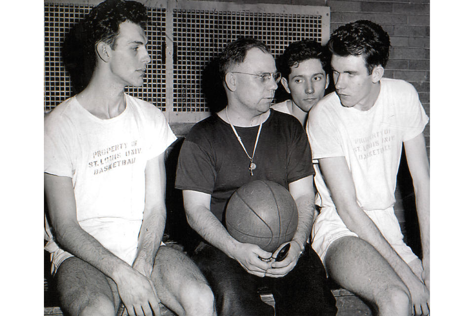 This undated photo provided by Saint Louis University Archives shows Saint Louis University NCAA college basketball coach Eddie Hickey and unidentified players. When the first AP Top 25 men's college basketball poll was published in January 1949, Saint Louis was installed at No. 1 ahead of mighty Kentucky, thanks to a head-to-head win a few weeks earlier in New Orleans.(Photo Courtesy of Saint Louis University Archives via AP)