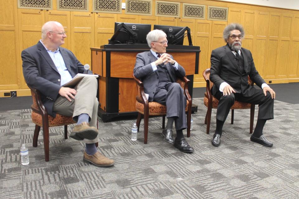 Moderator William Inboden III, left, professor and director of the Hamilton Center, listens to two renowned philosophers speak during a discussion titled “Truth-Seeking and Democracy." The panelists were Robert George center, and Cornel West, right.