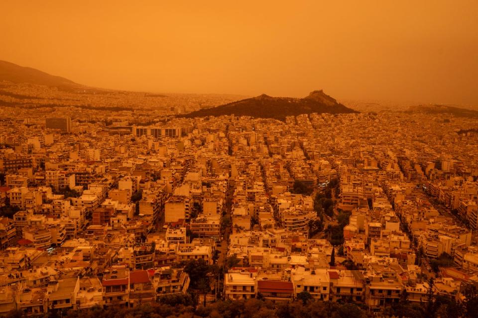 Athens shrouded in haze, as southerly winds carried waves of dust to the city (AFP via Getty Images)