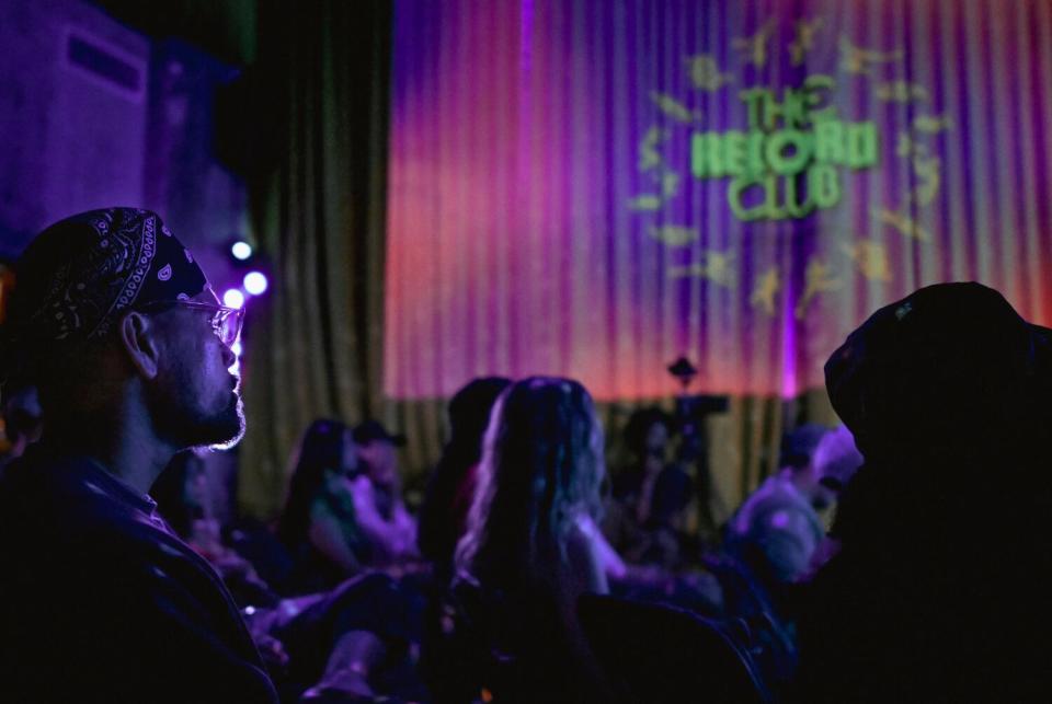 Guests listen intently to John Mayer's "Continuum" during an immersive album listening experience known as the Record Club.