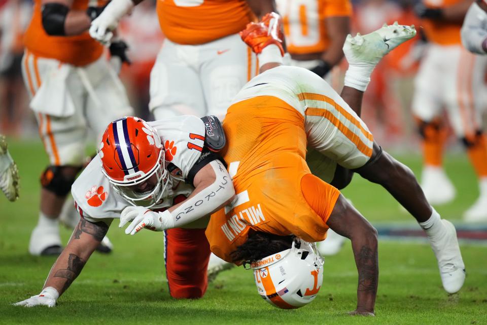 Dec 30, 2022; Miami Gardens, FL, USA; Clemson Tigers defensive tackle Bryan Bresee (11) sacks Tennessee Volunteers quarterback Joe Milton III (7) during the first half of the 2022 Orange Bowl at Hard Rock Stadium. Mandatory Credit: Jasen Vinlove-USA TODAY Sports