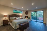 <p>The master bedroom features a fireplace and dual closets. (Zillow) </p>