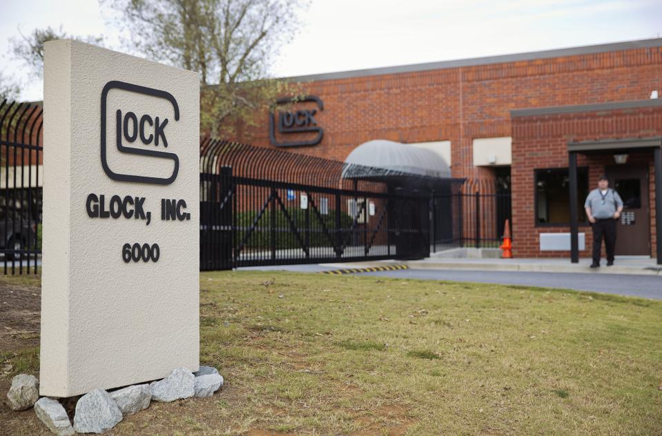 FILE - A security guard stands outside the Glock, Inc. headquarters, Oct. 8, 2014, in Smyrna, Ga. The city of Chicago sued Glock Inc. on Tuesday, March 19, 2024, alleging the handgun manufacturer is facilitating the proliferation of illegal machine guns that can fire as many as 1,200 rounds per minute on the streets of the city. (AP Photo/David Goldman, File)