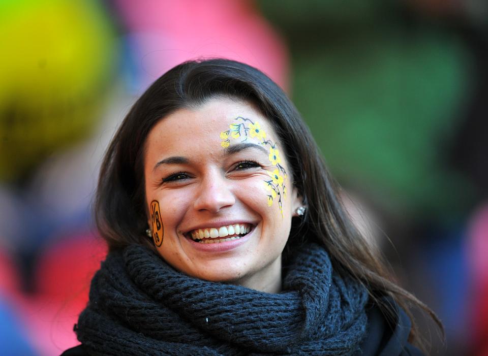 A Borussia Dortmund with her face painted in the stands