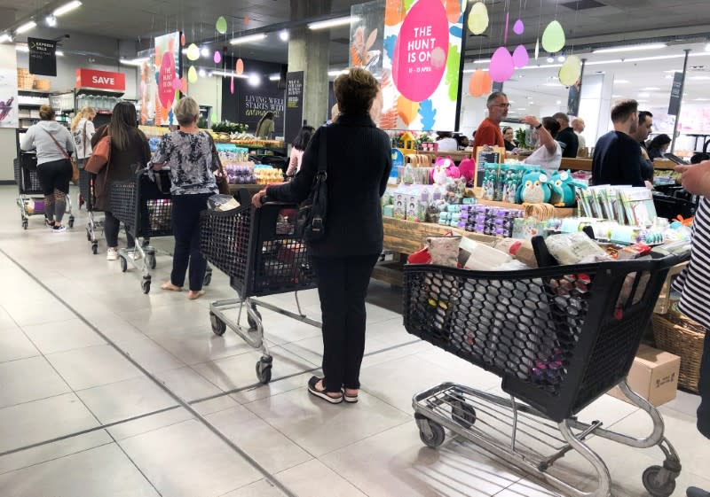 Shoppers queue to stock up on groceries ahead a nationwide lockdown called to limit the spread of coronavirus disease (COVID-19), in Cape Town