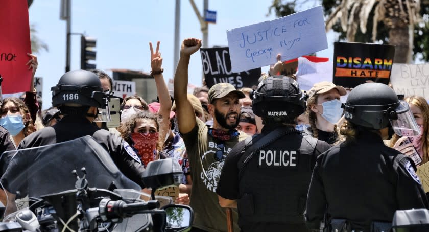 Protesters face off against Santa Monica police on Sunday.