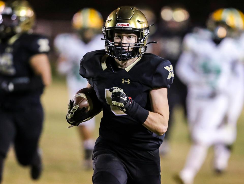 Xavier Prep's Braden Cervello (5) runs in a touchdown during the fourth quarter of their second-round playoff game at Xavier College Preparatory High School in Palm Desert, Calif., Friday, Nov. 10, 2023.