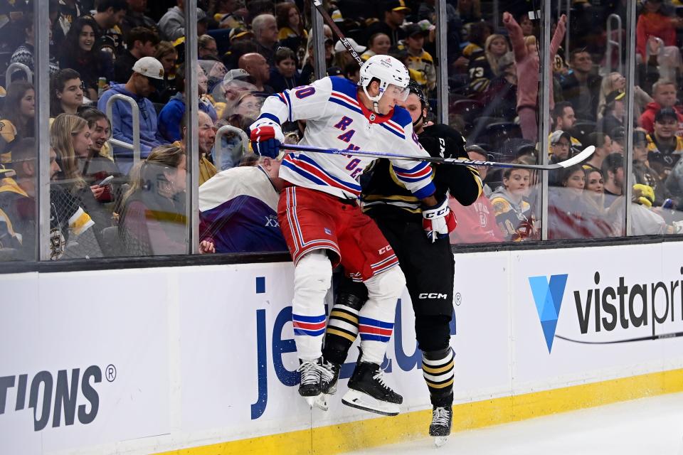 Sep 24, 2023; Boston, Massachusetts, USA; Boston Bruins defenseman Alec Regula (75) gets checked by New York Rangers left wing Will Cuylle (50) during the second period at TD Garden.