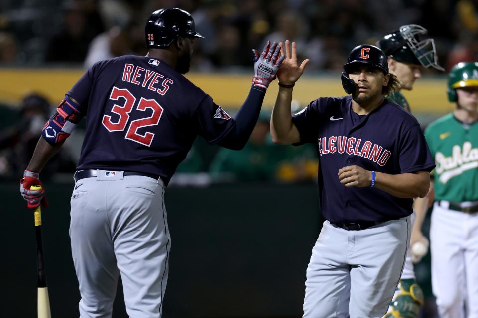 Cleveland Guardians' Josh Naylor, right, is congratulated by Franmil Reyes (32) after hitting a two-run home against the Oakland Athletics during the seventh inning of a baseball game in Oakland, Calif., Friday, April 29, 2022. (AP Photo/Jed Jacobsohn)