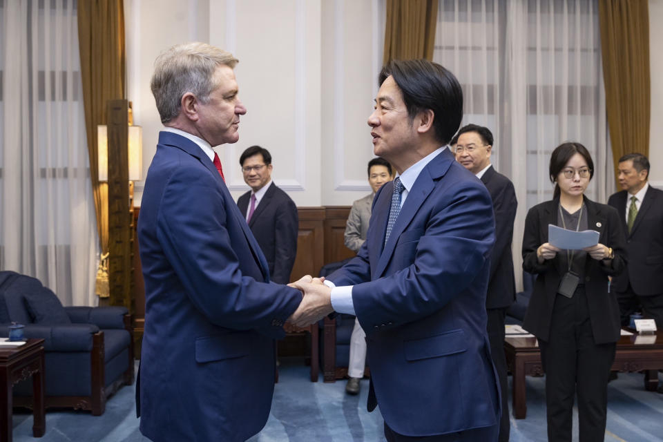 In this photo released by the Taiwan Presidential Office, Taiwan President Lai Ching-te, right, shakes hands with Rep. Michael McCaul, R-Texas during a meeting in Taipei, Taiwan, Monday, May 27, 2024. A U.S. congressional delegation met Taiwan's new leader on Monday in a show of support shortly after China held drills around the self-governing island in response to his inauguration speech. (Taiwan Presidential Office via AP)