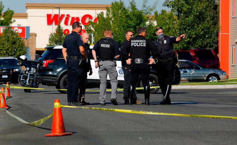 Kennewick police officers investigate the scene of a 2021 hit-and-run in the parking lot of a Kennewick apartment complex next to WinCo Foods. The city has approved a new ordinance for that troubled stretch of Clearwater Avenue.