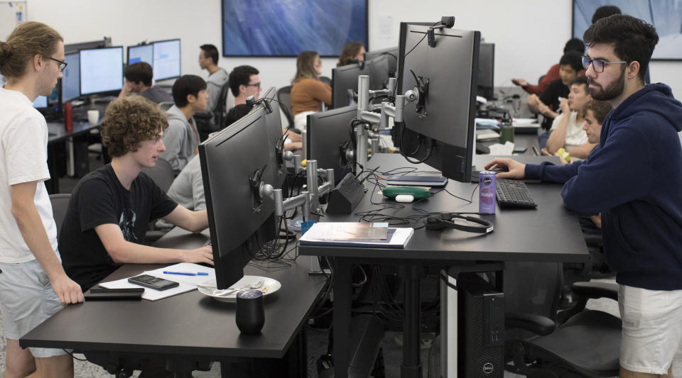 An office of workers in Sydney sitting at their computers.