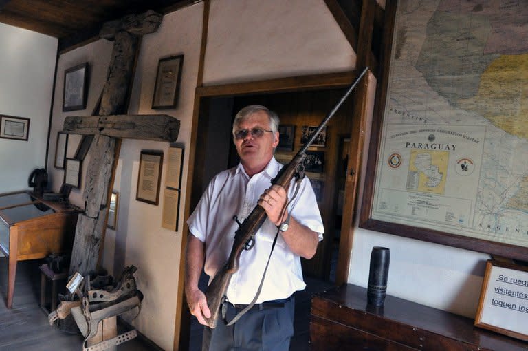 Hans Bochhmann, in charge of the Mennonite museum, shows a rifle used during Chaco's War, in Filadelfia, 500 km north of Asuncion, Paraguay, on November 3, 2012. Though the Mennonites of Paraguay's outback have found their way to prosperity, their community founders often faced religious persecution and went to extremes to reach what they saw as a kind of promised land