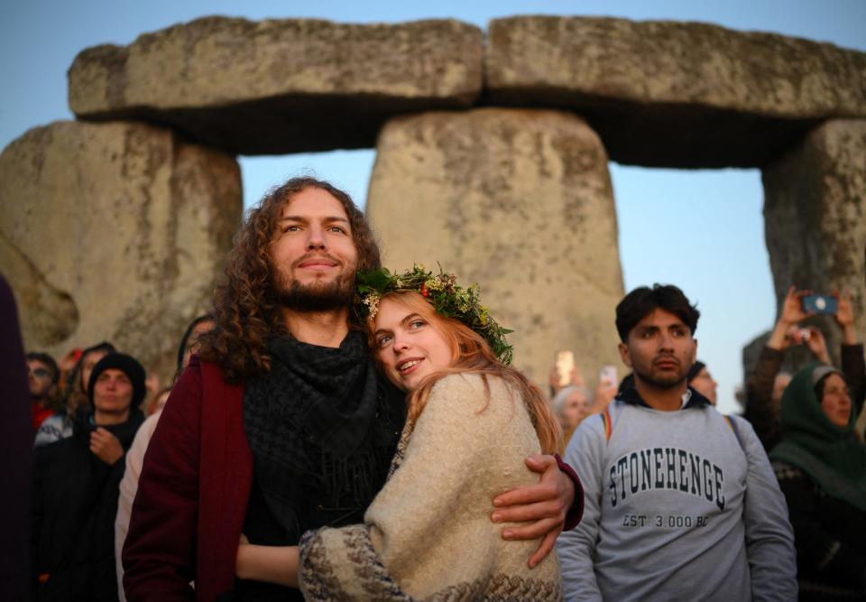 Revelers celebrate the summer solstice as the sun rises at Stonehenge, near Amesbury, in Wiltshire, southern England on June 21, 2023. This year, the solstice is on June 20, 2024, and is the earliest in over 200 years.