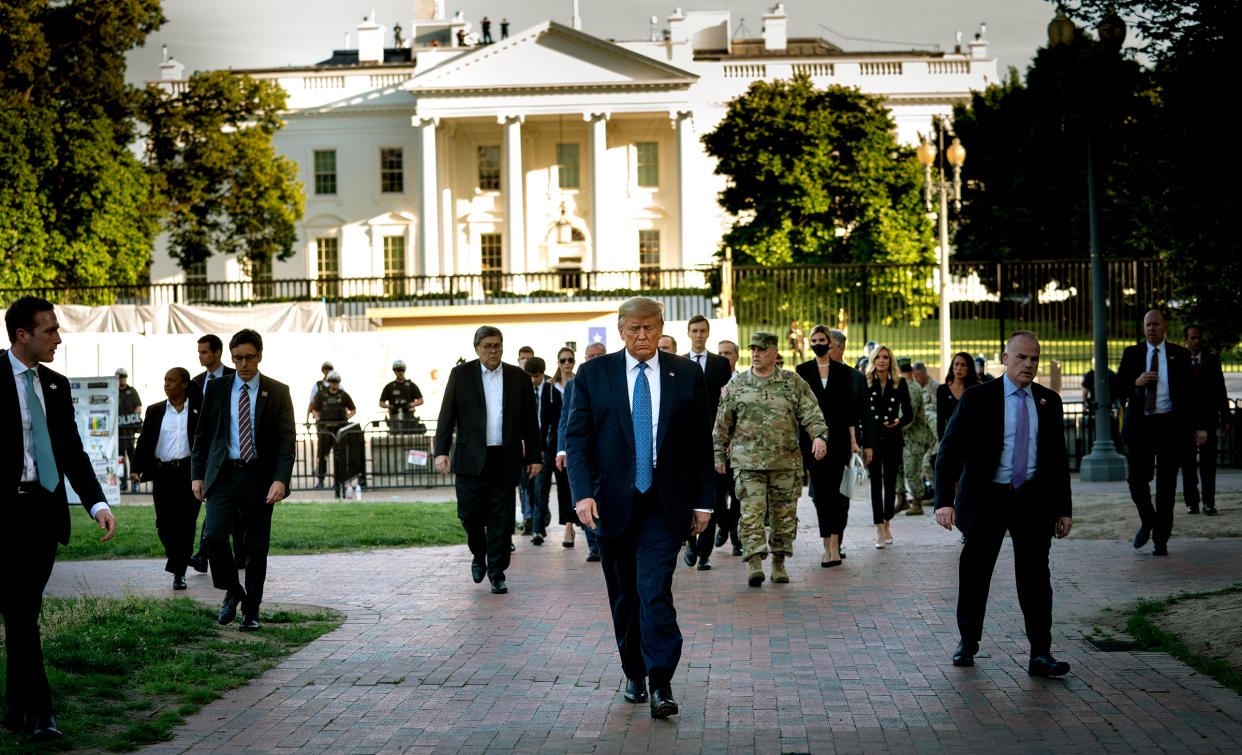 President Donald Trump, trailed by a group that includes Gen. Mark Milley, walks to St. John's Church after security forces cleared Lafayette Square near the White House on June 1, 2020.