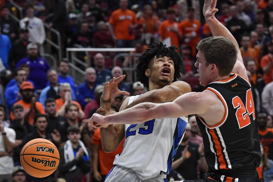 Creighton guard Trey Alexander (23) collides with Princeton guard Blake Peters (24) in the first half of a Sweet 16 round college basketball game in the South Regional of the NCAA Tournament, Friday, March 24, 2023, in Louisville, Ky. (AP Photo/Timothy D. Easley)