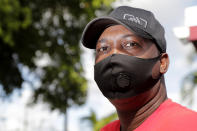 James Jackson poses for a photograph outside his home during the coronavirus pandemic, Thursday, July 30, 2020, in West Park, Fla. Jackson is among the tens of thousands hospitality workers fighting for survival in the age of the pandemic. Jackson's employer, the Diplomat Beach Resort, in Hollywood, Fla., was forced to close in March because of the outbreak. (AP Photo/Lynne Sladky)