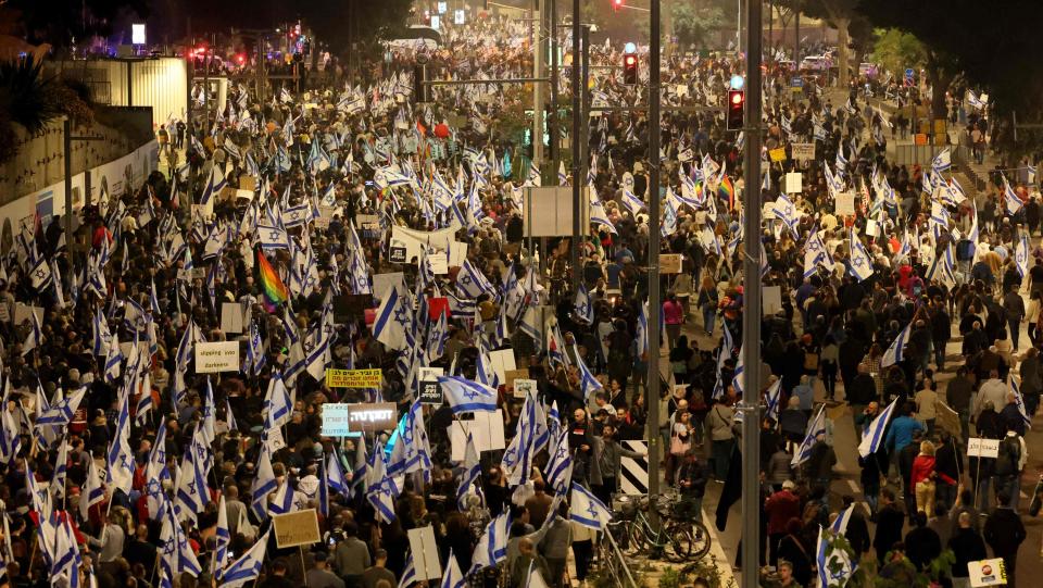 TOPSHOT - Israelis march in Tel Aviv on January 28, 2023 during a protest against controversial government plans to give lawmakers more control of the judicial system. - Prime Minister Benjamin Netanyahu and his allies, who have formed the most right-wing government in Israel's history, say the reforms are necessary to correct an imbalance that has given judges too much power over elected officials. (Photo by JACK GUEZ / AFP) (Photo by JACK GUEZ/AFP via Getty Images) ORIG FILE ID: AFP_33833R6.jpg