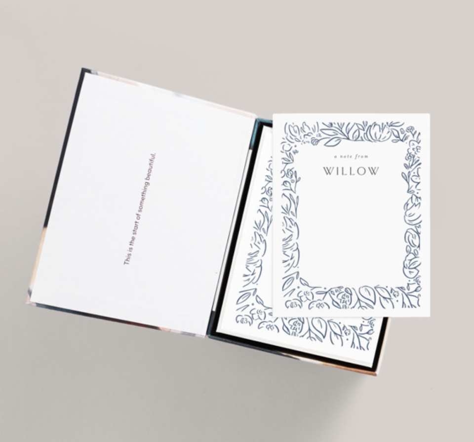 Personalized Stationery on white paper with blue floral trim (Photo via Minted)