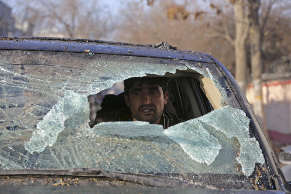 An Afghan driver looks out from a broken windshield of his car following the Friday's suicide attack and shooting in Kabul, Afghanistan, Saturday, Jan. 18, 2014. A Taliban suicide bomber and two gunmen on Friday attacked a Lebanese restaurant that is popular with foreigners and affluent Afghans in Kabul, a brazen attack that left 16 dead, including foreigners dining inside and two other gunmen, officials said. (AP Photo/Rahmat Gul)