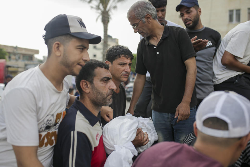 Palestinian mourners carry the body of a relative killed in an Israeli airstrike, at a morgue in Al-Aqsa Martyrs Hospital in Deir al Balah, the Gaza Strip, Monday, June 10, 2024. (AP Photo/Jehad Alshrafi)