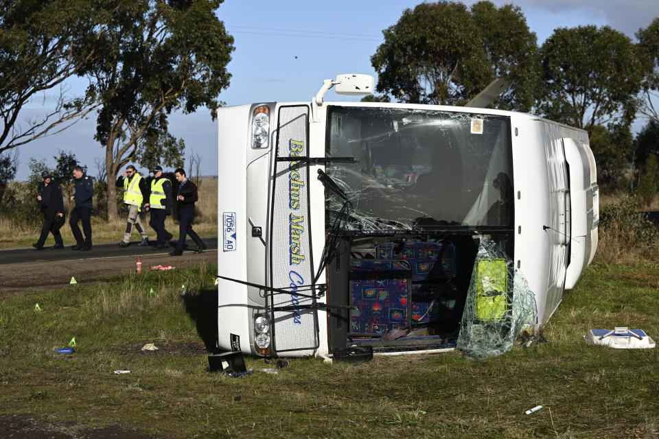 Investigators work at the scene of a bus crash near in Melbourne, Wednesday, May 17, 2023. Seven children remain hospitalized with serious injuries after a truck struck a school bus Tuesday carrying as many as 45 students on the outskirts of Melbourne in southeastern Australia. (Joel Carrett/AAP Image via AP)