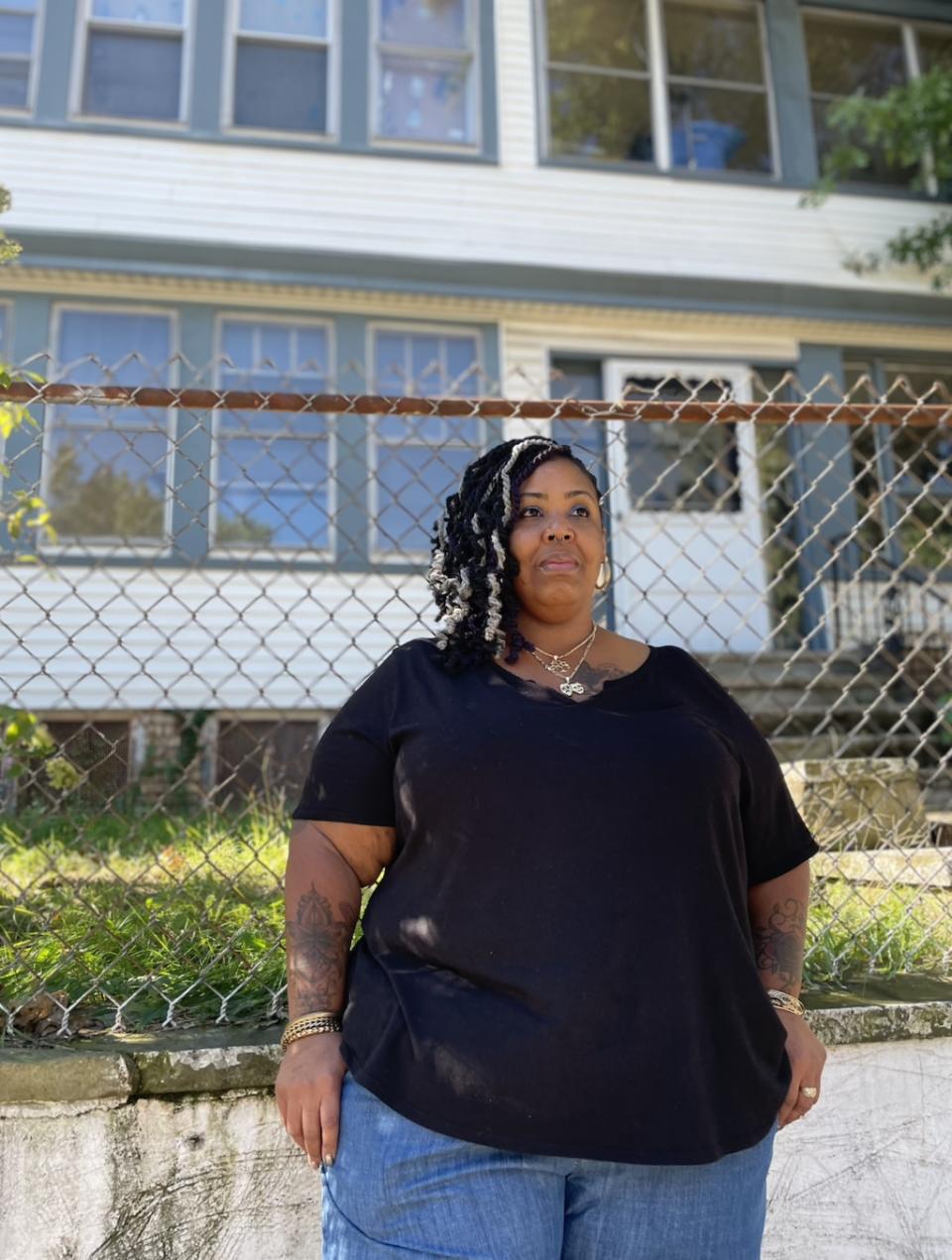 Latasha Tatum stands in front of her family home in Newark the week she’s required to leave. (Photo by Natasha S. Alford/theGrio)