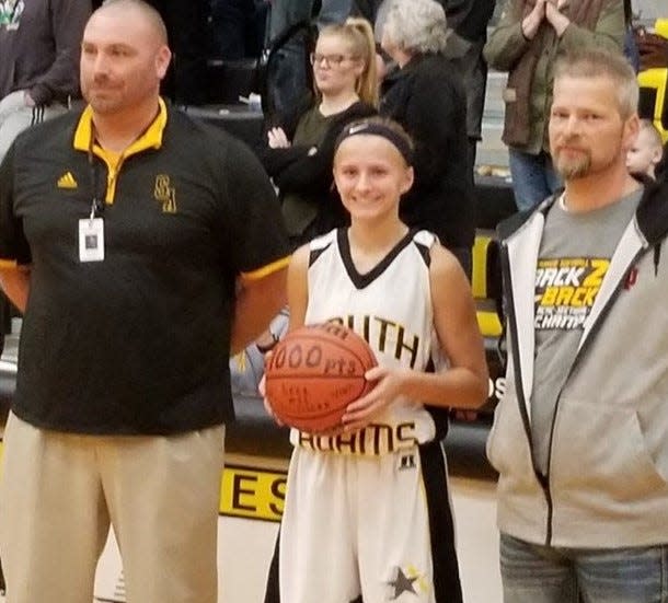 Lexi Dellinger broke the all-time scoring record at South Adams high school in 2018. To her left is AD Jason Arnold and father Steve Dellinger.