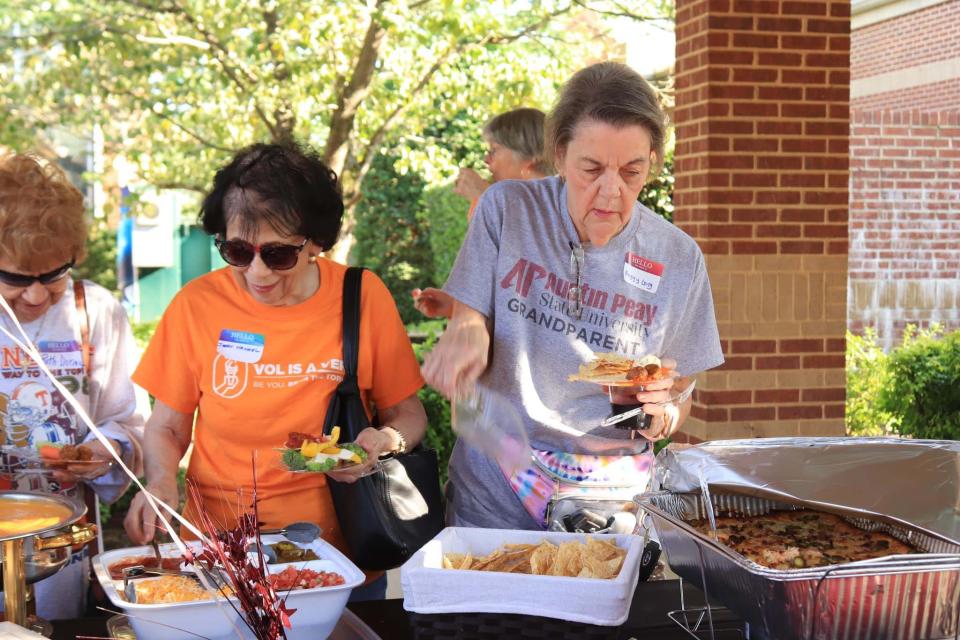 Jean Hannel and Peggy Long peruse the ample appetizer table by Classy Caterer at the All Saints Catholic Church Adult Social “Tailgates and Touchdowns,” Aug. 11, 2023.