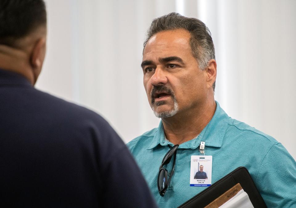 Stockton Unified School District emergency services/school safety coordinator Marcus Omlin, right, attends a board meeting at the SUSD headquarters in downtown Stockton on Thursday, Sept. 8. 2022.  