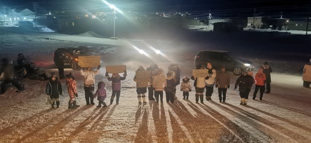 Pond Inlet, Nunavut, community members stand in solidarity with protesters in February at the Mary River mine outside the environmental hearings in the community. (Submitted by Enooki Inuarak  - image credit)