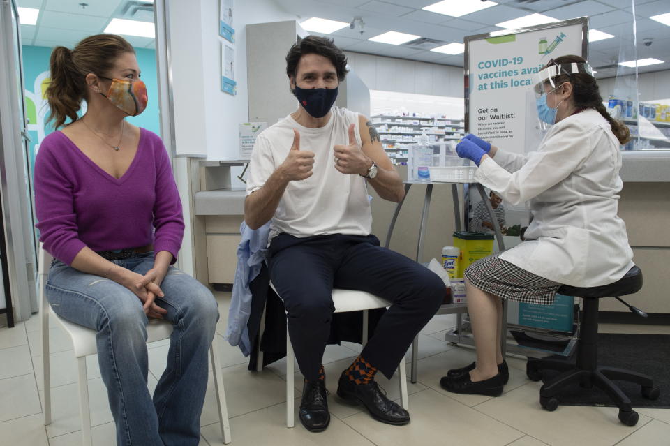 Sophie Gregoire Trudeau looks on as Prime Minister Justin Trudeau gives the thumbs up after being receiving his first COVID-19 AstraZeneca vaccination in Ottawa on Friday April 23, 2021. (Adrian Wyld/The Canadian Press via AP)