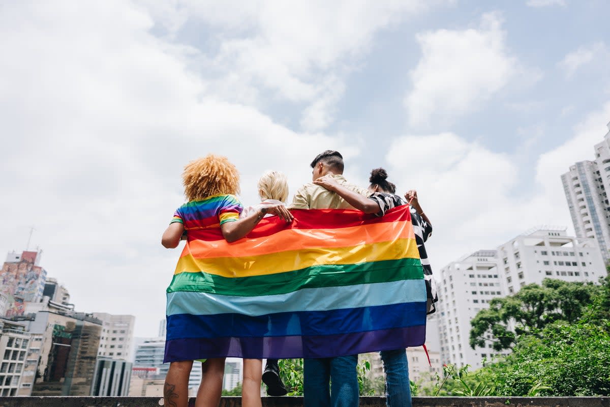 You don’t have to wrap yourself in a rainbow flag to be an LGBTQ+ ally as a straight person at pride — although you can! (Getty Images)