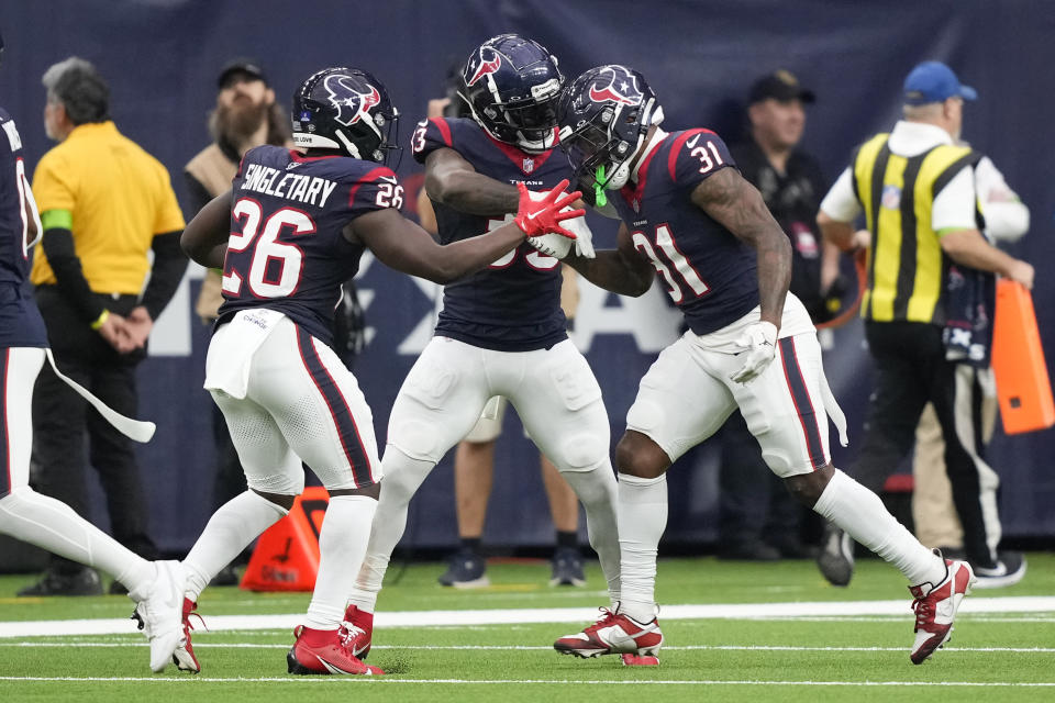 Houston Texans running back Dameon Pierce (31) celebrates with fellow running backs Devin Singletary (26) and Dare Ogunbowale (33) after returning a kickoff for a touchdown during the first half of an NFL football game against the Cleveland Browns, Sunday, Dec. 24, 2023, in Houston. (AP Photo/David J. Phillip)