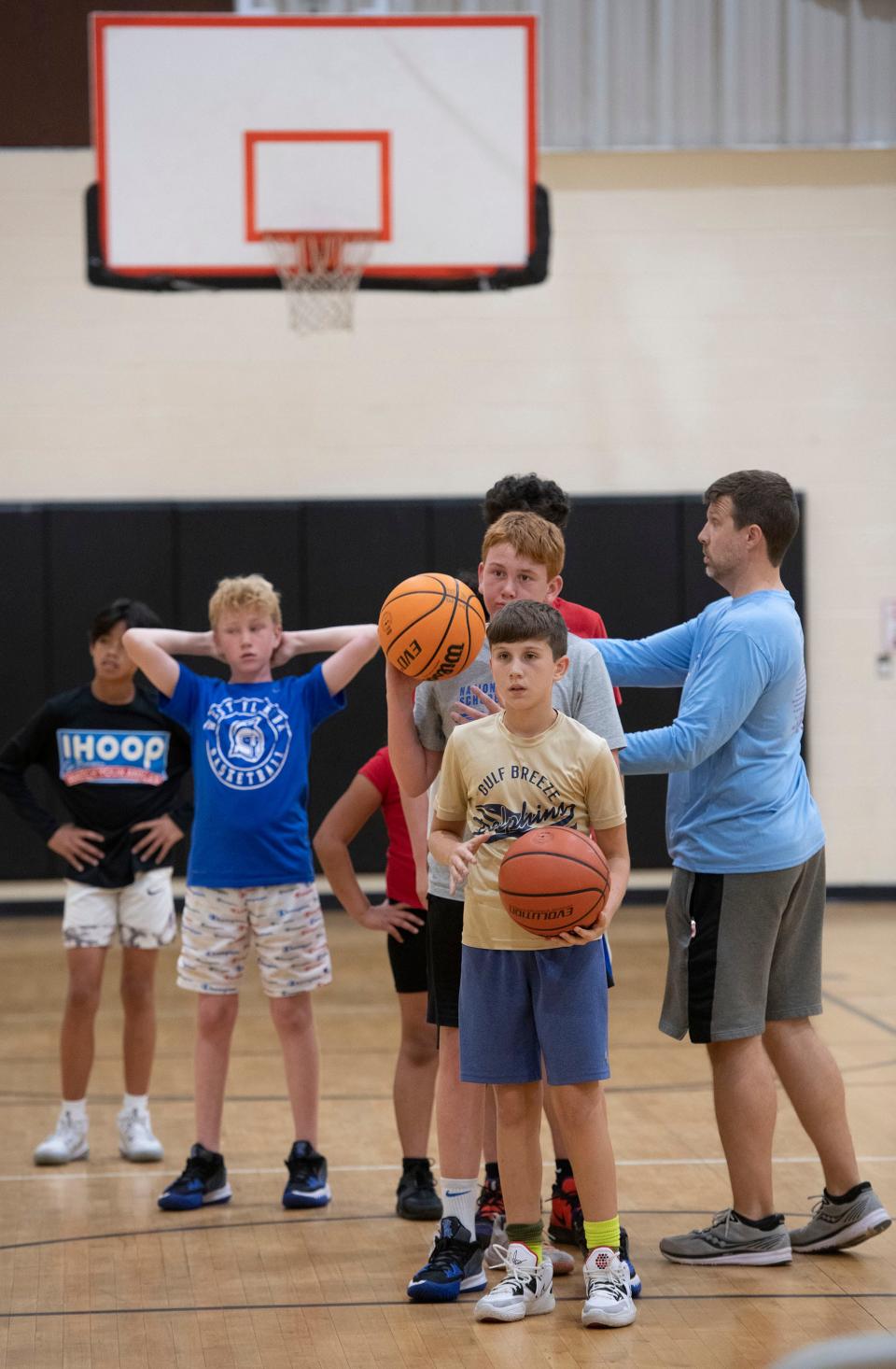 Reid Clark hones his basketball skills at a clinic for middle school students at the Wedgewood Community Center on Sept. 14. Clark is among the students from Santa Rosa County who travel to Escambia County to participate in youth sports.