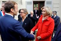 FILE PHOTO: French President Emmanuel Macron greets Paris' Ile de France president and candidate to the French right-wing Les Republicains primary election Valerie Pecresse at the Emile Zola house in Medan