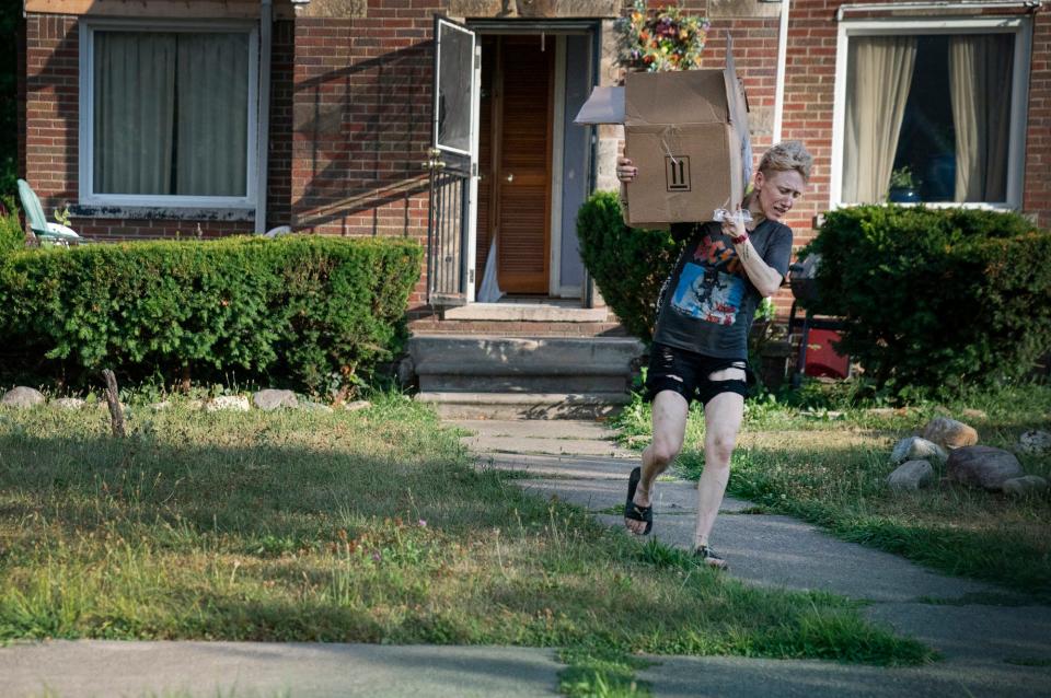 Amanda carries a box of harm reduction supplies for distribution on Monday, Aug. 1, 2022.